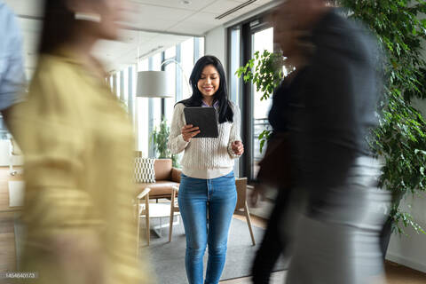 Femme au travaille qui regarde sa tablette